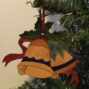 Christmas ornament, tooled leather cut out, handmade, bells, holly, red ribbon, blue, yellow