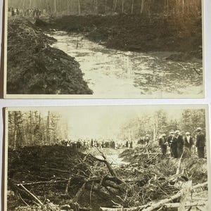May include: Two sepia-toned vintage photographs depicting a group of people gathered near a muddy, excavated trench in a wooded area. The images show piles of dark earth, scattered tree branches, and a forest background with tall, thin trees.