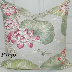 May include: Square decorative pillow with a floral pattern featuring pink lotus flowers, green lily pads, and a dragonfly on a light gray background. The pillow has the text "PW30" on the side.