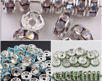 May include: Assortment of silver-toned metal bead caps with clear, blue, and green rhinestone accents. The bead caps are designed to cover the ends of cords or strings.