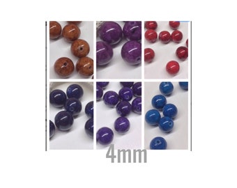 May include: Assortment of 4mm round beads in various colors, including red, purple, blue, and brown. The beads are made of a speckled material, giving them a unique look.