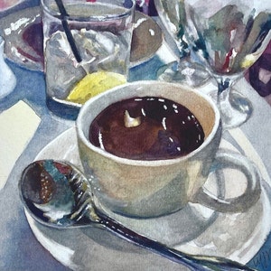 May include: A watercolour painting of a cup of coffee on a white saucer with a spoon. The coffee is dark brown and the cup is white with a light brown rim. The saucer is white with a light blue rim. The spoon is silver and has a light blue handle.