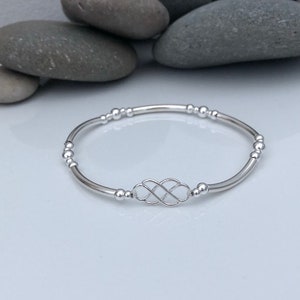 Sterling silver celtic knot bracelet.  Sterling silver beaded stretch bracelet with celtic knot charm.