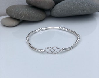 Sterling silver celtic knot bracelet.  Sterling silver beaded stretch bracelet with celtic knot charm.