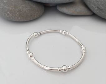 Sterling silver stretch bracelet. Stacking bracelets. Beaded stretch bracelet. Sterling silver tube bracelet. Sterling silver bangle