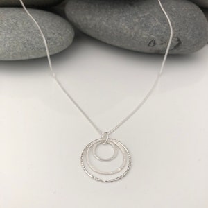 Sterling silver triple graduating circle necklace. 3 ring pendant.