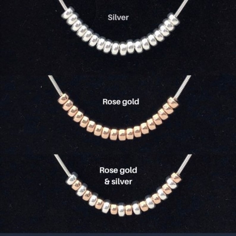 Three rows of beads with silver, rose gold, and a combination of rose gold and silver beads. The beads are displayed against a black background.