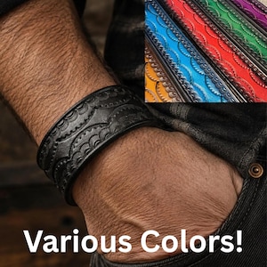 May include: A wide leather cuff bracelet featuring a repeating embossed scalloped pattern. The bracelet is available in multiple colours including black, orange, blue, red, green, and purple, as shown in the inset image with the text Various Colours.