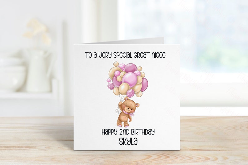 May include: A birthday card with a cute cartoon bear holding pink and beige balloons. The card says "To a very special great niece" and "Happy 2nd Birthday Skyla".