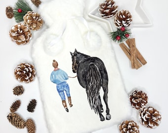 May include: White faux fur hot water bottle cover with a watercolor illustration of a person riding a black horse. The person is wearing blue jeans and a light blue shirt.
