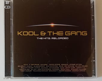 May include: A CD case featuring the album "KOOL & THE GANG: THE HITS: RELOADED." The cover is dark brown with gold lettering and a stylized graphic. The CD case is clear plastic and contains two CDs.