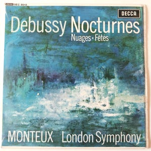 May include: A square vinyl record cover featuring an abstract blue and white painting. The text reads Debussy Nocturnes Nuages Fêtes, MONTEUX, London Symphony, and DECCA. The top left corner displays stereo SEC 5510 in small white lettering.