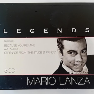 May include: A black CD box set with the word "LEGENDS" in white capital letters. The box features a black and white photo of Mario Lanza, and the text "BECAUSE YOU'RE MINE", "AVE MARIA", and "SERENADE FROM 'THE STUDENT PRINCE'".
