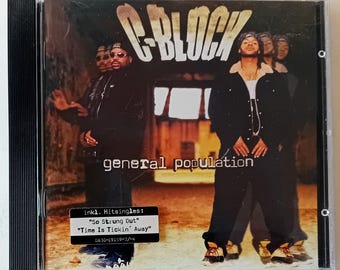 May include: CD case for the album "General Population" by C-Block. The cover shows a group of men in dark clothing against a blurred background. The album title is in white block letters. Includes the singles "So Strung Out" and "Time Is Tickin' Away".