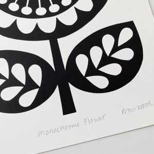 May include: Black and white print of a stylized flower with the text "Monochrome Flower" and the artist's signature "Fran Wood".