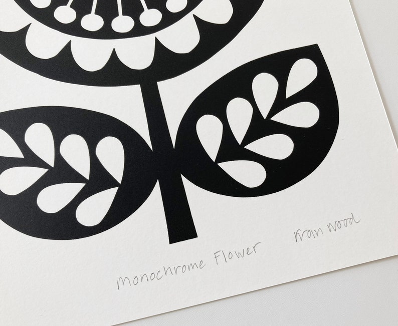 May include: Black and white print of a stylized flower with the text "Monochrome Flower" and the artist's signature "Fran Wood".