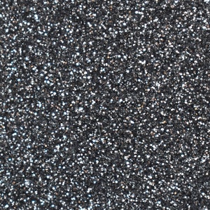 May include: Close-up of a surface covered in small, reflective, silver and black glitter particles. The glitter creates a textured, sparkling effect, ideal for crafts, decorations, or adding shimmer to various projects.