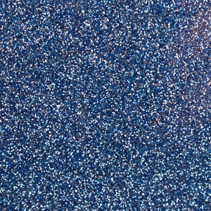 May include: A close-up shot of a textured surface covered in small, reflective blue glitter particles. The glitter is densely packed, creating a shimmering effect. The overall appearance is a solid, sparkling blue.