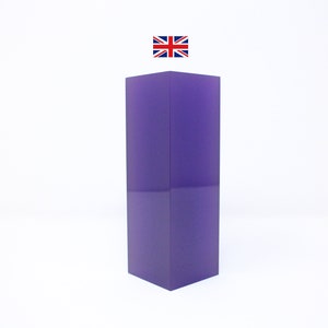 May include: A tall, rectangular purple acrylic block. The block is smooth and has a slight sheen.