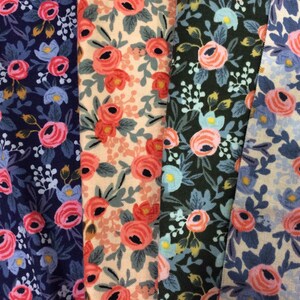 May include: Four fabric swatches with floral patterns. The swatches are in shades of blue, pink, green, and beige. The floral patterns are all different, but they all have a similar style.