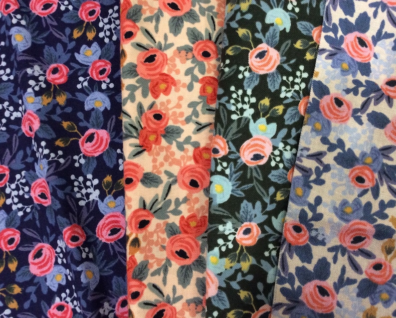 May include: Four fabric swatches with floral patterns. The swatches are in shades of blue, pink, green, and beige. The floral patterns are all different, but they all have a similar style.