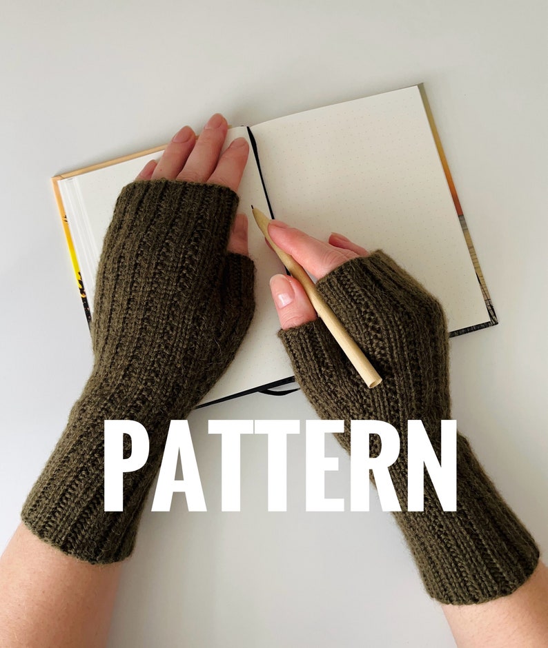 May include: A pair of olive green fingerless knitted gloves with the word "PATTERN" in white text.