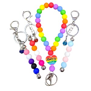 May include: A rainbow beaded keychain with a heart charm that says "love is love". The keychain has a silver ring and a silver clip.