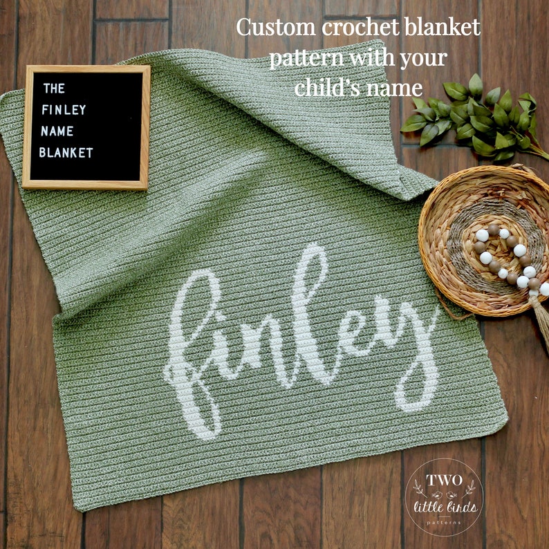 May include: A sage green crochet blanket with the name "Finley" in white script. The blanket is displayed on a wooden surface, with a framed sign that reads "THE FINLEY NAME BLANKET". The text "Custom crochet blanket pattern with your child's name" is also visible.