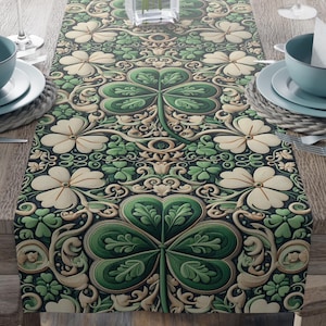 May include: A green and white table runner with a shamrock pattern. The runner is decorated with intricate floral designs and has a dark green background.