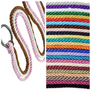 May include: A close-up of two cords of braided rope, one pink and white and the other brown and white. The cords are twisted together and are shown against a white background. A selection of 20 different colors of braided rope is shown in the background.