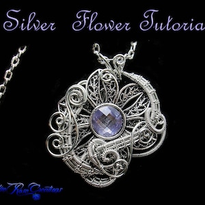 Peut inclure: Un pendentif en fil d'argent en forme de fleur avec une pierre précieuse violette au centre. Le pendentif est attaché à une chaîne en argent.