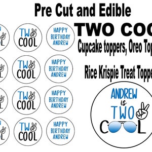 May include: A set of 12 round edible cupcake toppers featuring a blue and black design with the text "Andrew is Two Cool" and a peace sign. The toppers are perfect for a birthday party.