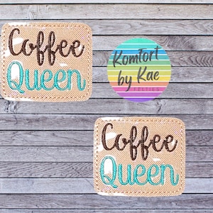 May include: Two beige felt patches with brown and teal embroidery that reads "Coffee Queen". A rainbow circle with the text "Komfort by Kae FELTIES" is in the background.