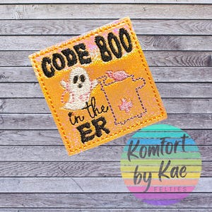 May include: Embroidered orange patch with the text "CODE BOO" and "in the ER" in black. A white ghost and a pink medical symbol are also featured. The patch is a Halloween-themed item.