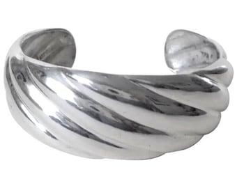 May include: A silver bangle bracelet with a twisted, ribbed design.