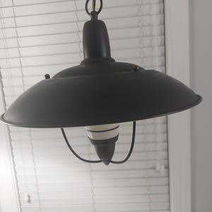 May include: A black metal pendant light fixture with a white and black striped glass shade.