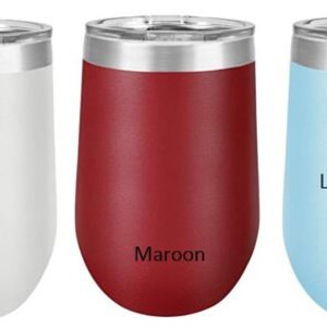 May include: Three stainless steel wine tumblers in white, maroon, and light blue. The tumblers have a silver lid and a rounded bottom. The colors are labeled below each tumbler.
