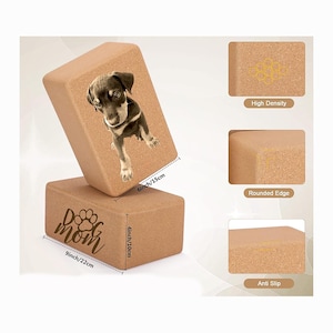 May include: Two rectangular yoga blocks made of cork. One block has a printed image of a puppy. The other block has the words "Dog mom" and a paw print. The blocks are 9 inches/22cm long, 6 inches/15cm wide, and 4 inches/10cm high.