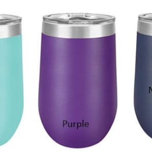 May include: Three stainless steel wine tumblers in teal, purple, and navy blue. The tumblers have a double-wall insulated design and are labeled with their respective colors.