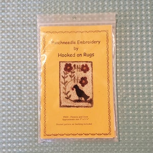 May include: A yellow card with the text "Punchneedle Embroidery by Hooked on Rugs" and a black and white image of a crow with flowers. The text "PN30 - Flowers and Crow" and "Approximate size 3" x 3 1/4" is also on the card.