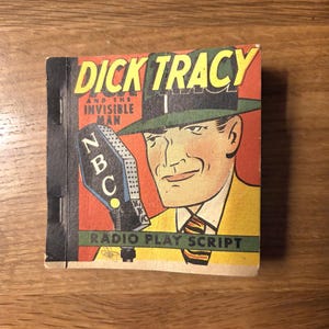 May include: Vintage "Dick Tracy and the Invisible Man" radio play script. The cover features a comic illustration of Dick Tracy in a green hat and yellow suit, holding a microphone with "NBC" on it. The title is in yellow letters.
