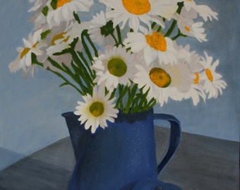 May include: A blue ceramic pitcher filled with a bouquet of white daisies with yellow centers. The pitcher is sitting on a wooden table with a blue background.