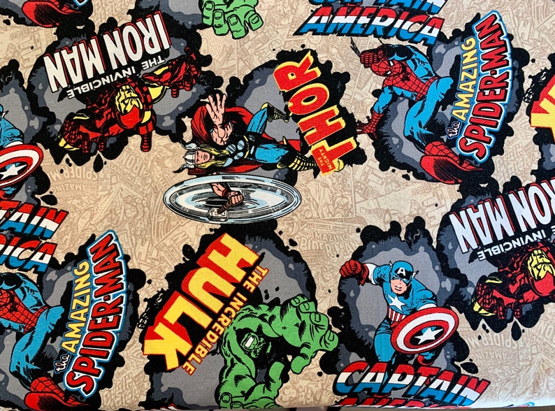 May include: A colourful fabric with a repeating pattern of comic book characters, including Spider-Man, Captain America, Thor, Hulk, and Iron Man. The fabric features the text "The Incredible Hulk", "The Amazing Spider-Man", "Captain America", "Thor", and "Iron Man".