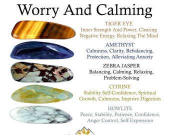 May include: A collection of five polished stones labeled Worry And Calming. The stones include golden-brown Tiger Eye, deep purple Amethyst, black and white Zebra Jasper, translucent yellow Citrine, and white Howlite with grey veining.