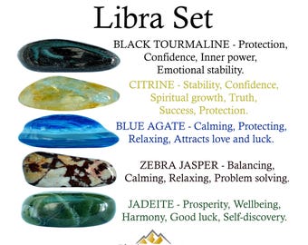 May include: A Libra Set collection of five polished stones: black tourmaline, yellow citrine, blue agate, brown and white zebra jasper, and green jadeite. Text labels list each stone name and associated qualities, with the RhodopeMinerals logo below.