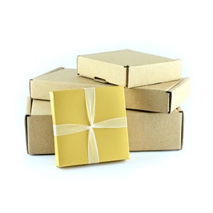 May include: A stack of four brown cardboard boxes with a gold gift box tied with a white ribbon on top.