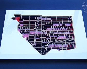 Intricate, shimmering, laser cut map of Northcote, Victoria with red fabric infused acrylic.