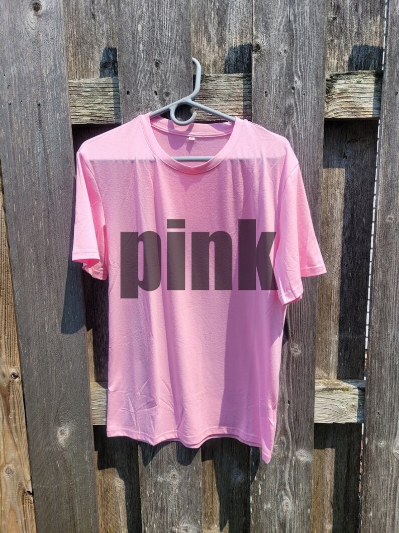 May include: A pink t-shirt with the word "pink" printed in black on the front.