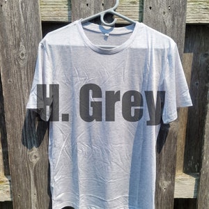 May include: A light gray t-shirt with the text "H. Grey" printed in black on the front.