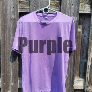 May include: A purple t-shirt with the word "Purple" printed on the front.